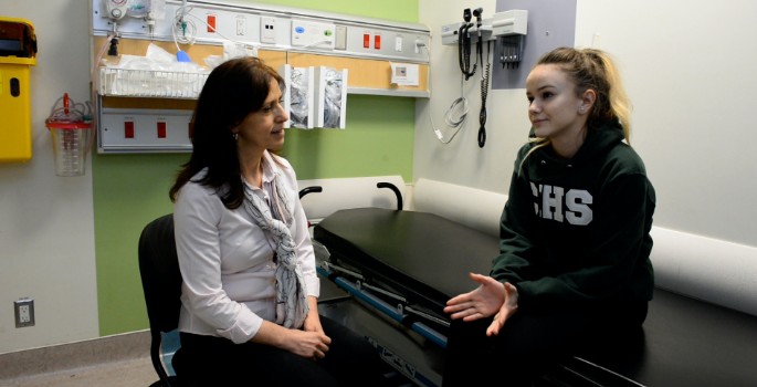 Youth and a CHEO staff member in a hospital room